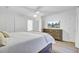 Bright bedroom with hardwood floors, ceiling fan, TV and ensuite bathroom at 60 Fairway Dunes Ln, Isle of Palms, SC 29451