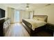 Bright bedroom featuring a queen bed, white bedding, decorative pillows, and light hardwood floors at 60 Fairway Dunes Ln, Isle of Palms, SC 29451