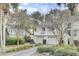Inviting two-story home with a double garage and a charming second-floor balcony at 60 Fairway Dunes Ln, Isle of Palms, SC 29451