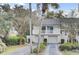 Inviting two-story home with a double garage and a charming second-floor balcony at 60 Fairway Dunes Ln, Isle of Palms, SC 29451