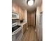 Efficient kitchen with wooden cabinets, white appliances, and plenty of storage space and modern flooring at 60 Fairway Dunes Ln, Isle of Palms, SC 29451