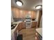 Well-lit kitchen featuring wooden cabinets, white appliances, and modern countertops and flooring at 60 Fairway Dunes Ln, Isle of Palms, SC 29451