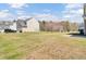 A large backyard with a healthy lawn and an outbuilding in the distance at 629 English Oak Cir, Moncks Corner, SC 29461