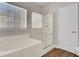 Bright bathroom with a tub, glass shower door, and window for natural light at 629 English Oak Cir, Moncks Corner, SC 29461