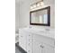 Bathroom with double sinks, large mirror, white cabinets, and updated hardware at 629 English Oak Cir, Moncks Corner, SC 29461