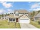 Charming two-story home with a manicured lawn, a two car garage, and an inviting entrance at 629 English Oak Cir, Moncks Corner, SC 29461