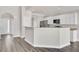 Open kitchen featuring stainless appliances, a breakfast bar, and wood floors at 629 English Oak Cir, Moncks Corner, SC 29461