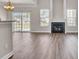 Open-concept living room with hardwood floors, a fireplace, and sliding glass doors to the outside at 629 English Oak Cir, Moncks Corner, SC 29461