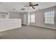 Spacious living area with carpet flooring, ceiling fan, and lots of natural light at 629 English Oak Cir, Moncks Corner, SC 29461