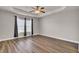 Spacious main bedroom with tray ceiling, ceiling fan, and hardwood floors at 629 English Oak Cir, Moncks Corner, SC 29461
