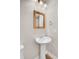 Powder room with pedestal sink, updated lighting, and a decorative mirror at 629 English Oak Cir, Moncks Corner, SC 29461