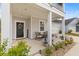Charming front porch features a cozy seating area and stylish door with a wreath at 68 Red Bluff St, Summerville, SC 29483