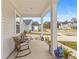 Inviting front porch with rocking chairs, perfect for relaxing and enjoying the neighborhood view at 68 Red Bluff St, Summerville, SC 29483