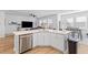 Bright kitchen with white cabinetry, stainless steel appliances, and an open view to the living area at 68 Red Bluff St, Summerville, SC 29483