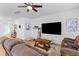 Spacious living room featuring wood flooring, a ceiling fan, and comfortable seating arrangements at 68 Red Bluff St, Summerville, SC 29483