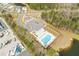 Aerial shot of a community pool with ample parking, playground, and lake views at 68 Red Bluff St, Summerville, SC 29483