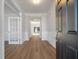 Inviting entryway showcasing wood-look floors, white trim, and a decorative glass door at 8703 Forte Dr, North Charleston, SC 29406