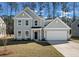 Charming two-story home featuring a gray facade, attached garage, and well-maintained lawn at 8703 Forte Dr, North Charleston, SC 29406