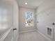 Well-lit laundry room with tile flooring and a view of the outdoors at 8703 Forte Dr, North Charleston, SC 29406
