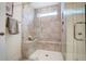Contemporary tiled shower with a glass enclosure, built-in bench, and a convenient window at 8703 Forte Dr, North Charleston, SC 29406