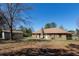Expansive backyard view with a detached garage, patio, and the back of the brick home at 105 Wade Ct, Summerville, SC 29486