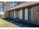 Brick-faced home with large shuttered windows, landscaped entrance and sidewalk access at 105 Wade Ct, Summerville, SC 29486
