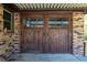 Stunning wood grain garage door with beautiful wood framing and brick siding at 105 Wade Ct, Summerville, SC 29486