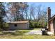 A detached garage located within a wooded backyard and a poured concrete pad at 105 Wade Ct, Summerville, SC 29486