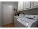 Neat laundry area with white washer and dryer, cabinets, and essentials for efficient chore management at 105 Wade Ct, Summerville, SC 29486