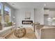 Bright living room featuring modern fireplace, hardwood floors, and views into the modern kitchen at 108 Brown Swiss Cir, Summerville, SC 29483