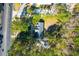 An aerial view of the home and property amidst lush trees and a nearby roadway at 10812 Dorchester Rd, Summerville, SC 29485