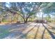 Expansive backyard featuring mature trees, outbuildings, and potential for outdoor activities at 10812 Dorchester Rd, Summerville, SC 29485
