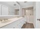 Bright bathroom featuring a double vanity with a large mirror and walk in shower at 10812 Dorchester Rd, Summerville, SC 29485