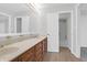 Bright bathroom featuring a double vanity with a large mirror and wood look flooring at 10812 Dorchester Rd, Summerville, SC 29485
