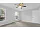 Neutral bedroom featuring two windows, a ceiling fan and carpet at 10812 Dorchester Rd, Summerville, SC 29485