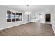 Dining room with large picture window and modern chandelier, transitioning to adjacent kitchen at 10812 Dorchester Rd, Summerville, SC 29485