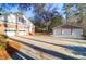 Home's driveway leading to two brick buildings, including the attached two-car garage at 10812 Dorchester Rd, Summerville, SC 29485