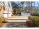 Home's driveway and garage, with a basketball hoop and trees in the distance at 10812 Dorchester Rd, Summerville, SC 29485