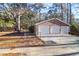 Detached garage featuring three bays, brick facade, and a large driveway at 10812 Dorchester Rd, Summerville, SC 29485
