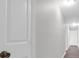 Well lit hallway with white doors and trim and wood look floors at 10812 Dorchester Rd, Summerville, SC 29485