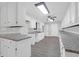 Galley-style kitchen with white cabinets, modern countertops, and a contemporary ceiling fan at 10812 Dorchester Rd, Summerville, SC 29485