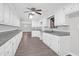 Well-lit kitchen featuring white cabinets, modern countertops, and stainless steel sink at 10812 Dorchester Rd, Summerville, SC 29485