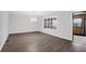 Bright living room features gray walls, modern light fixture, and wood-look flooring at 10812 Dorchester Rd, Summerville, SC 29485