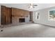 Bright living room featuring brick fireplace and multiple windows offering scenic views at 10812 Dorchester Rd, Summerville, SC 29485