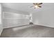 Open-concept living room featuring neutral tones, modern ceiling fan, and access to additional living spaces at 10812 Dorchester Rd, Summerville, SC 29485