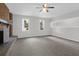 Spacious living room featuring a brick fireplace, ample natural light, and modern ceiling fan at 10812 Dorchester Rd, Summerville, SC 29485