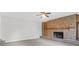 Cozy living room with a prominent brick fireplace and classic wood mantle at 10812 Dorchester Rd, Summerville, SC 29485
