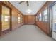 Large sunroom with wood paneling, carpet, and abundant natural light from multiple windows at 10812 Dorchester Rd, Summerville, SC 29485