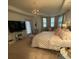 Bright bedroom with checkered bedding, chandelier, TV, and reading nook for relaxation and entertainment at 112 Amanda Cir, Goose Creek, SC 29445