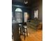 Cozy living room has black walls, and features hardwood floors, a bar, and a couch by the windows at 112 Amanda Cir, Goose Creek, SC 29445